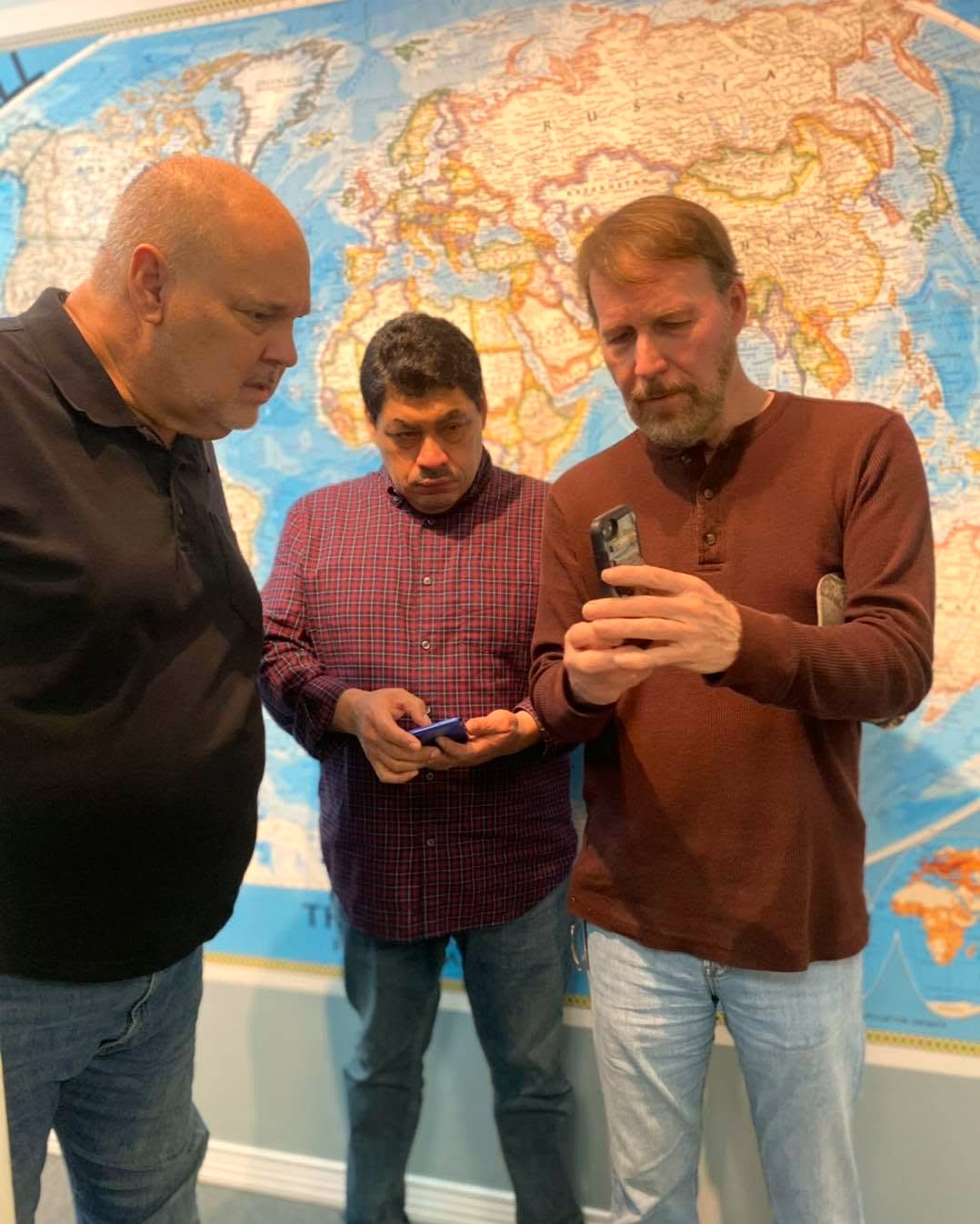 IGO leaders gathered before a world map, planning gospel work across the nations