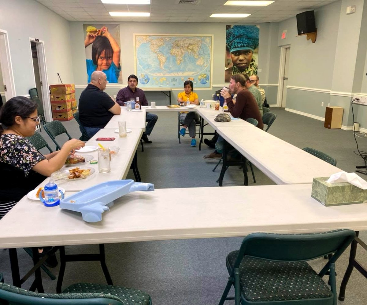 Gathered beneath the world map to support missionaries across the regions